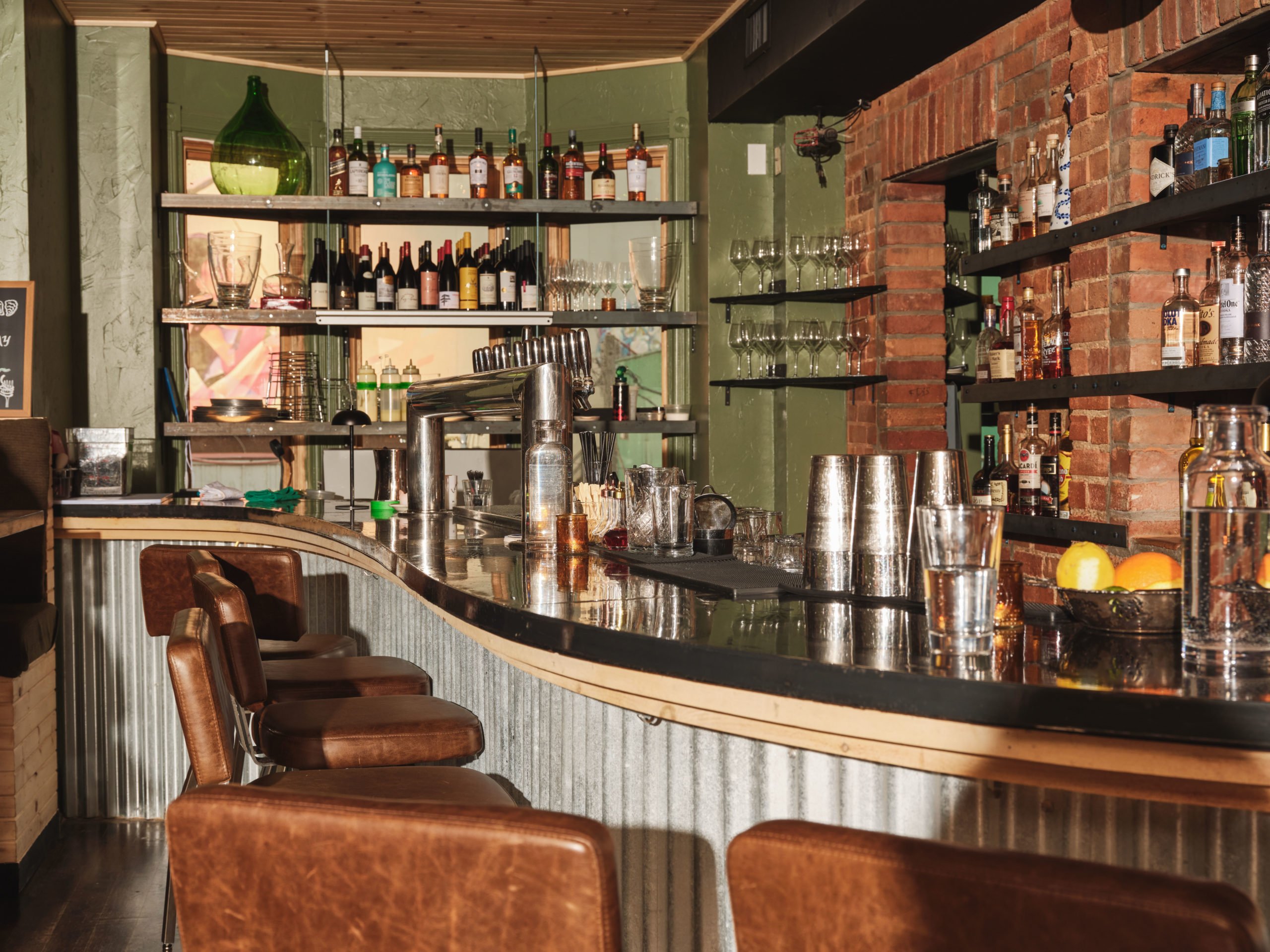 A bar lined with barstools