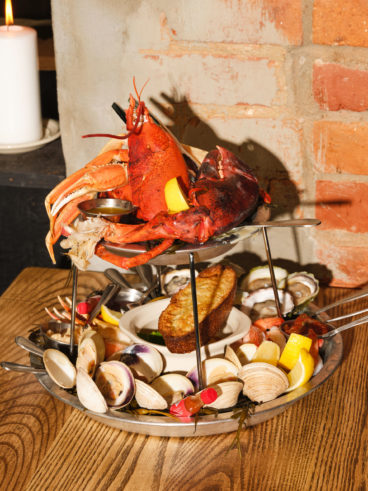 A seafood tower with a pound of poached lobster, crab legs, poached black tiger shrimp, eight oysters, eight clams, snow crab claws, a mussel escabeche with toasted garlic focaccia and all the necessary fixings: mignonette, horseradish, melted butter and lemon wedges