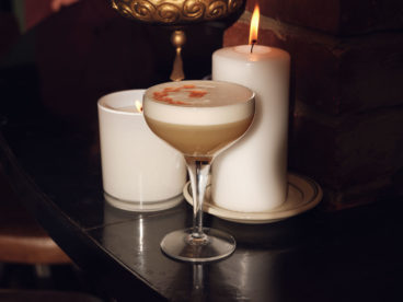 A whiskey topped with sugar and whipped aquafaba